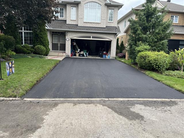 Freshly paved asphalt driveway at a home in Ottawa