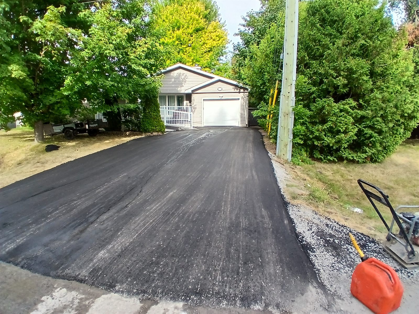 Newly paved asphalt driveway at a bungalow in Ottawa