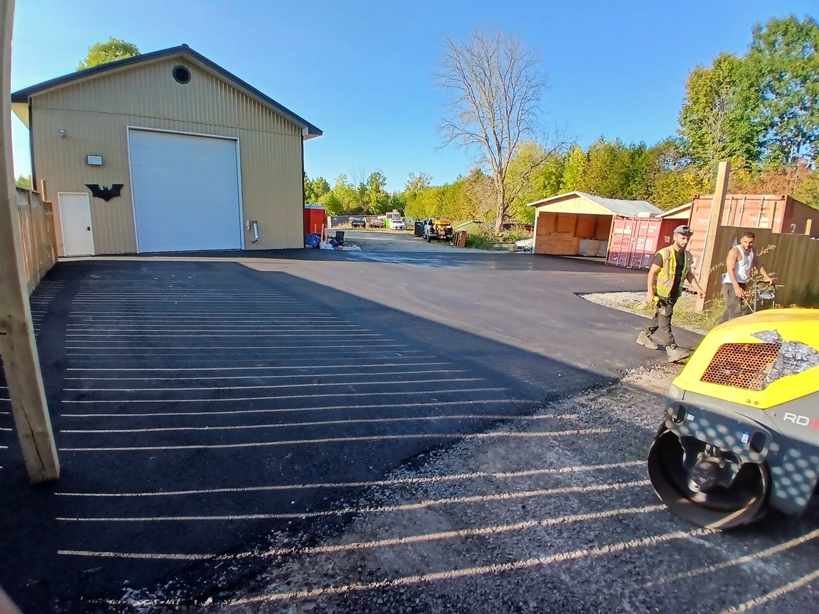 Newly paved commercial asphalt lot beside a shop building in Ottawa