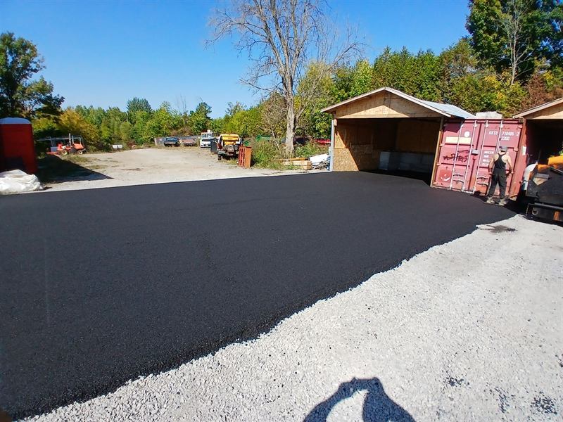 Large freshly paved asphalt pad at a commercial yard in Ottawa