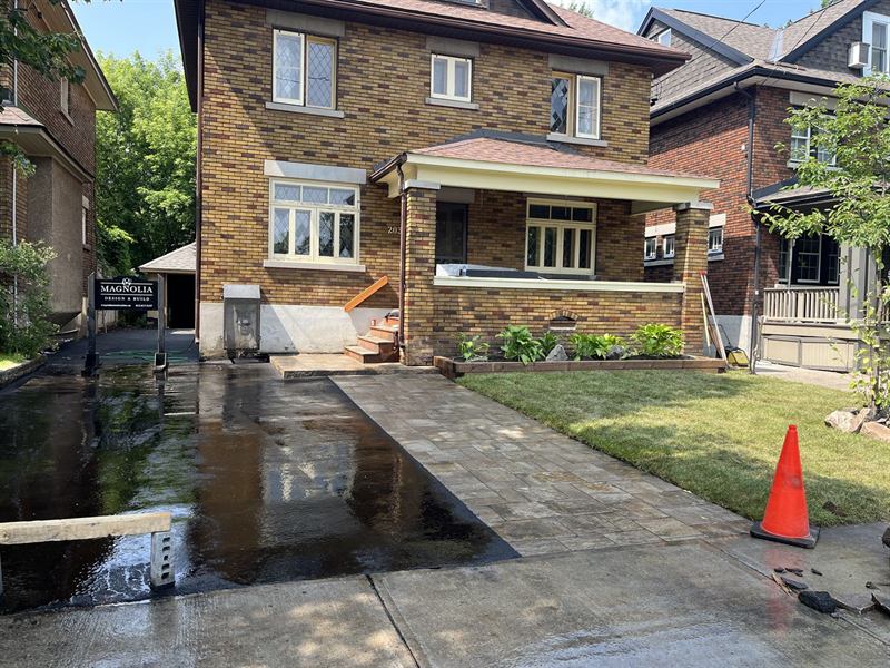 Freshly sealcoated asphalt driveway at a brick home in Ottawa