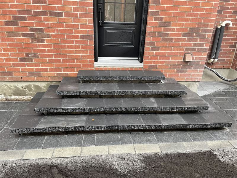 Interlocking paver front entrance steps at a brick home in Ottawa