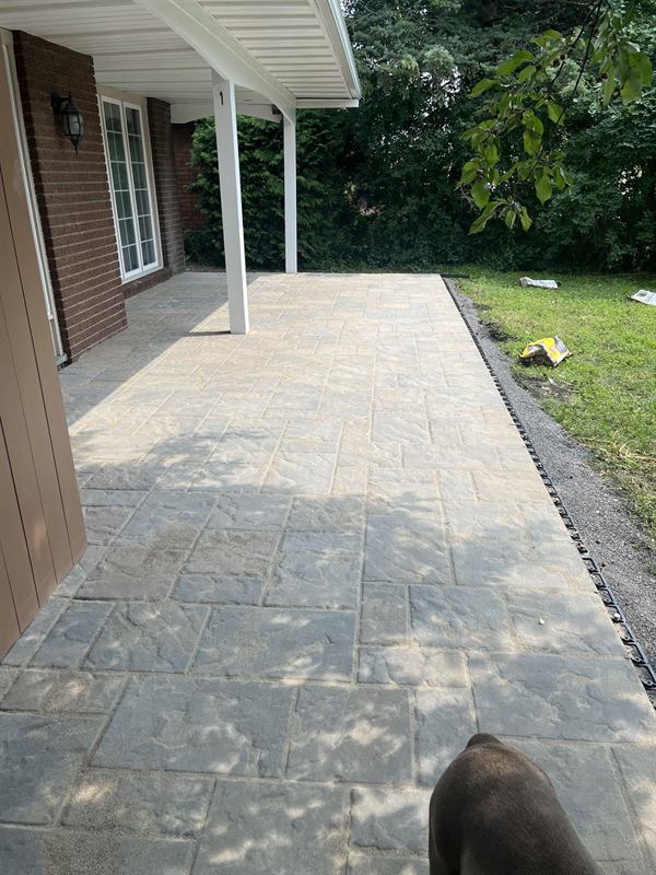 Interlocking paver patio under a covered porch at an Ottawa home