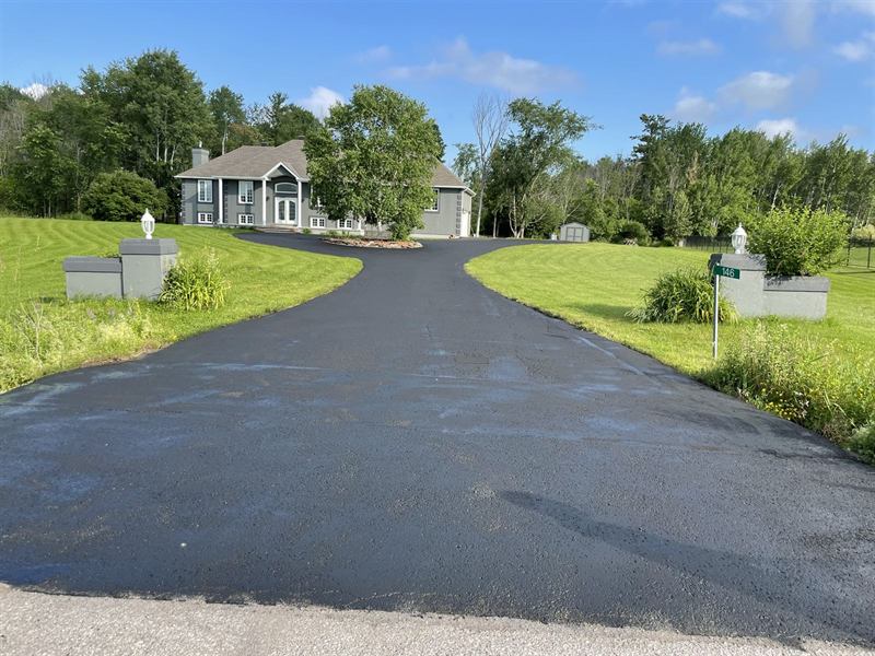 Long curved asphalt driveway paved by Proseal Plus at a rural Ottawa property