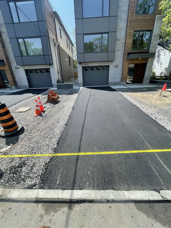 Asphalt driveway with a concrete border at a modern Ottawa townhome