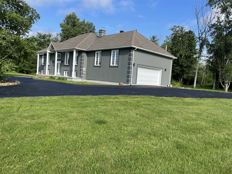 Long asphalt approach paved at a country property outside Ottawa
