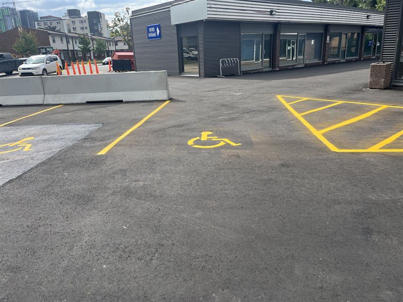 Accessible parking space symbol and hatched access aisle painted in an Ottawa lot