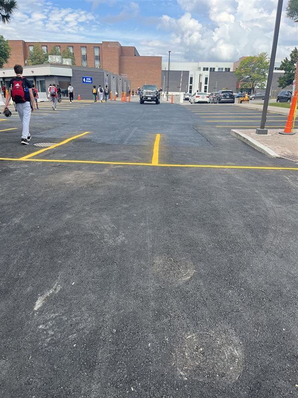 Freshly painted yellow parking stall markings in an Ottawa parking lot