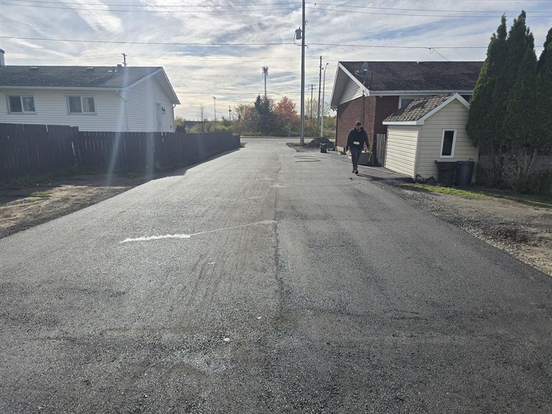 Freshly paved private roadway running between homes in Ottawa