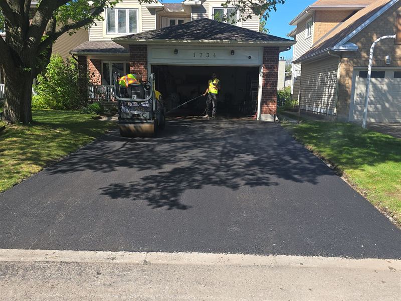 Proseal Plus crew paving and compacting a residential driveway in Ottawa