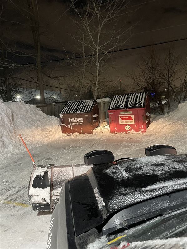 Snow cleared and stacked at the edge of a commercial parking lot in Ottawa